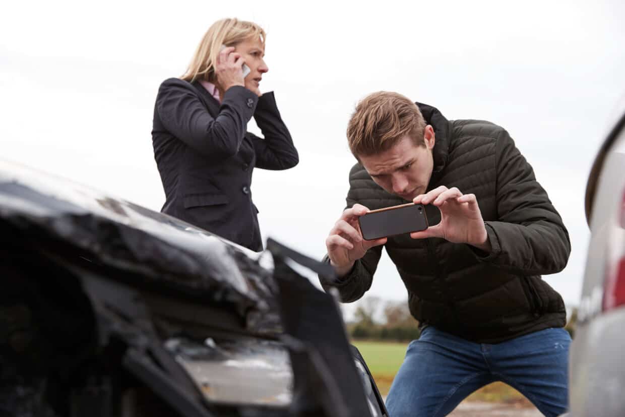 Abbey Court Solicitors | Accidents Caused by an Untraced or Uninsured DriverTwo people documenting car accident damage with smartphone Two people documenting car accident damage with smartphone