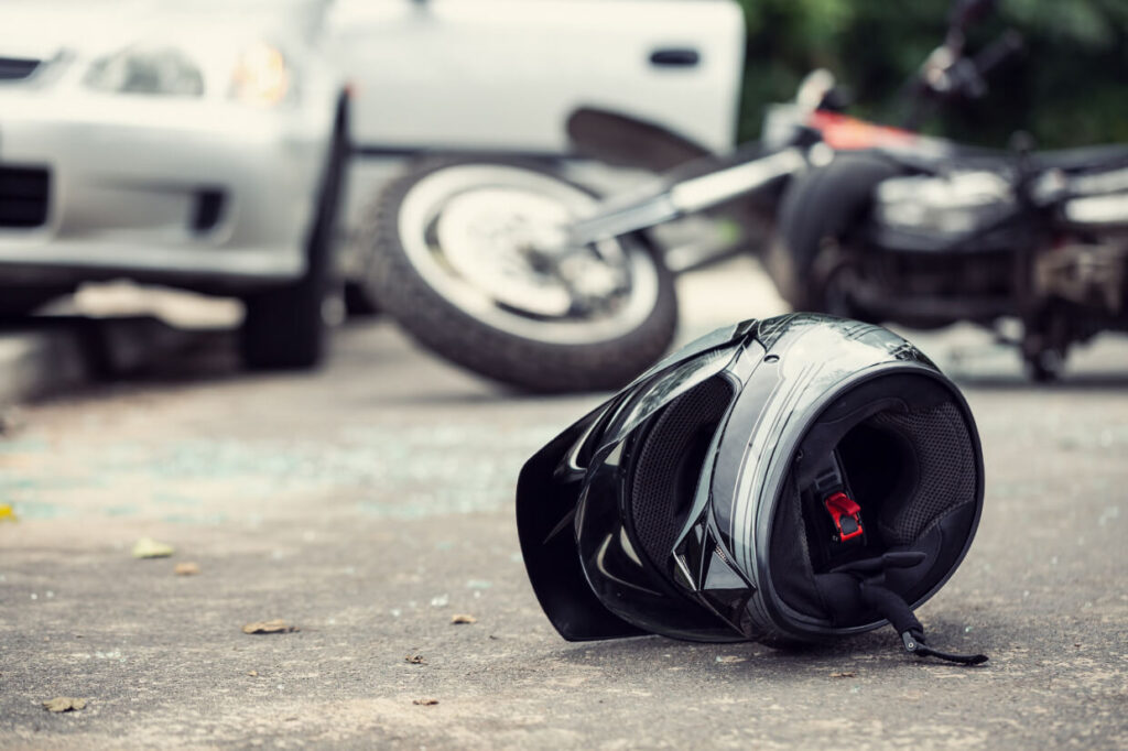Motorcycle helmet on road after accident with vehicles
