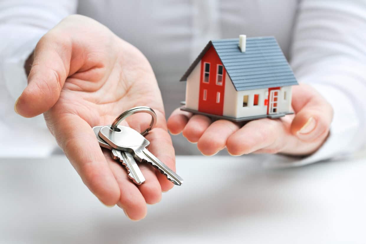 Abbey Court Solicitors | The steps involved in selling a propertyPerson holding house keys and miniature red home model Person holding house keys and miniature red home model