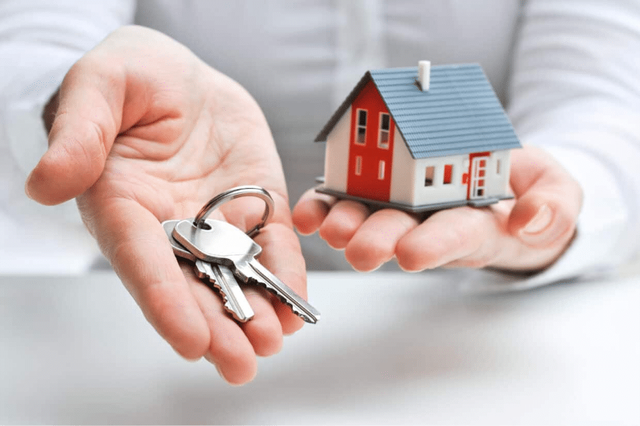 Abbey Court Solicitors | Buying or Selling a House? Why You Need the Best Property Solicitors Person holding house keys and miniature model home Abbey Court Solicitors | Buying or Selling a House? Why You Need the Best Property Solicitors Person holding house keys and miniature model home