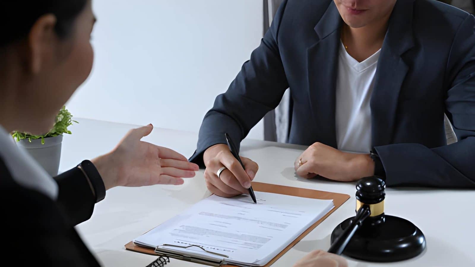 How Do Child Custody Agreements Work in England? Lawyer and client discussing legal documents at desk
