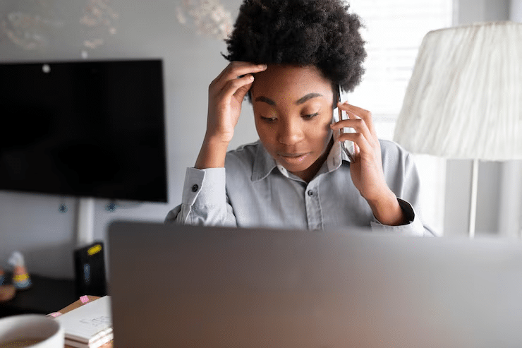 Abbey Court Solicitors | Stress Psychological Injury At WorkWoman on phone looking stressed at laptop desk Woman on phone looking stressed at laptop desk