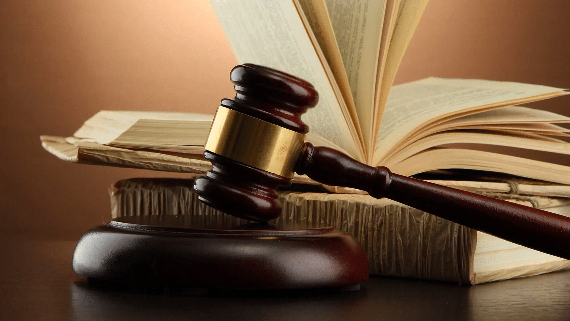 Abbey Court Solicitors | LitigationJudge's gavel and open law book on wooden desk Judge's gavel and open law book on wooden desk