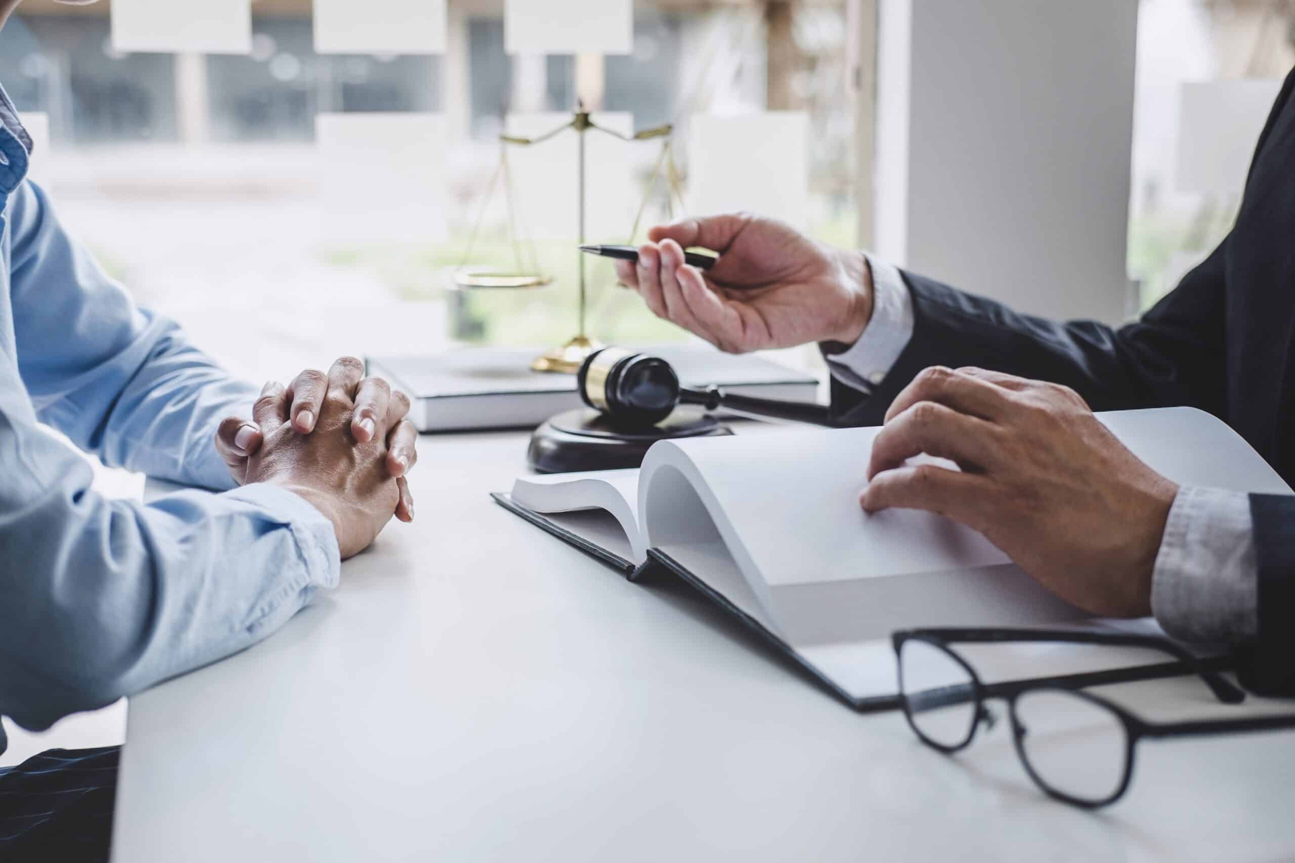 Consultation and conference of Male lawyers and professional bus Lawyer and client discussing legal documents at office desk