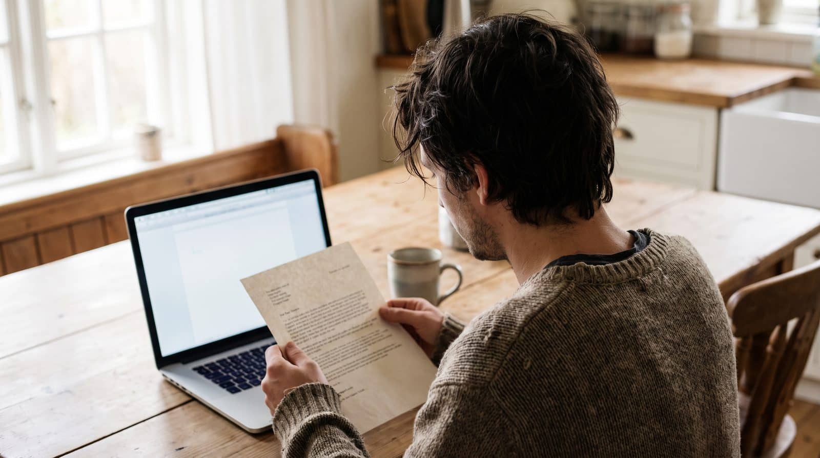 Person reading a letter before deciding between a small claim and civil litigation Person reading a letter before deciding between a small claim and civil litigation